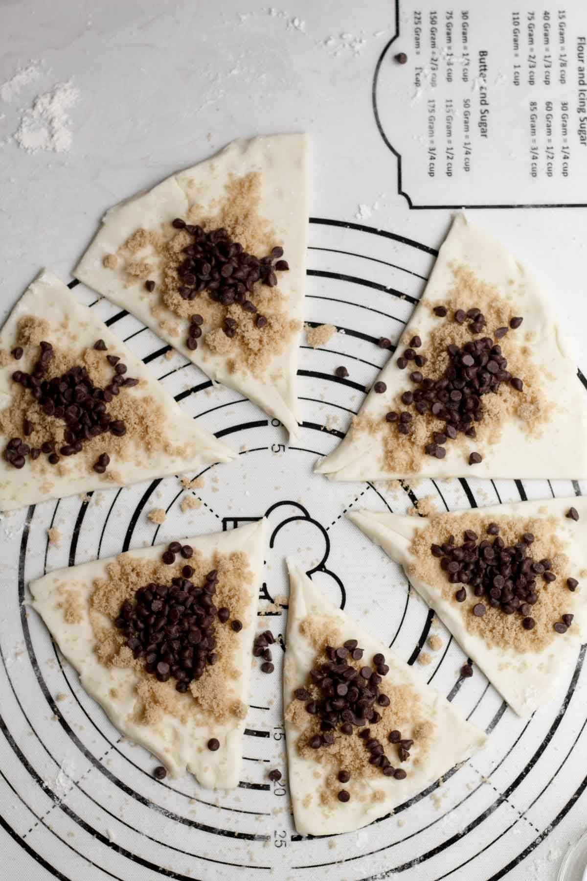 Topping the triangles with brown sugar and mini chocolate chips.