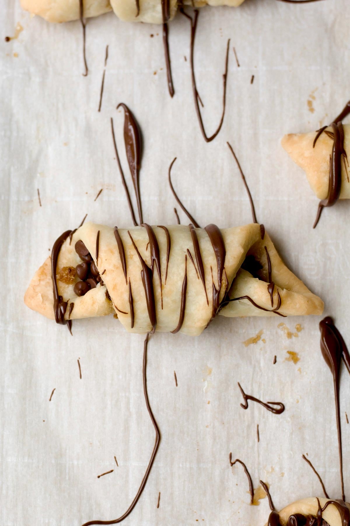 Baked puff pastry twists drizzled in melted chocolate.