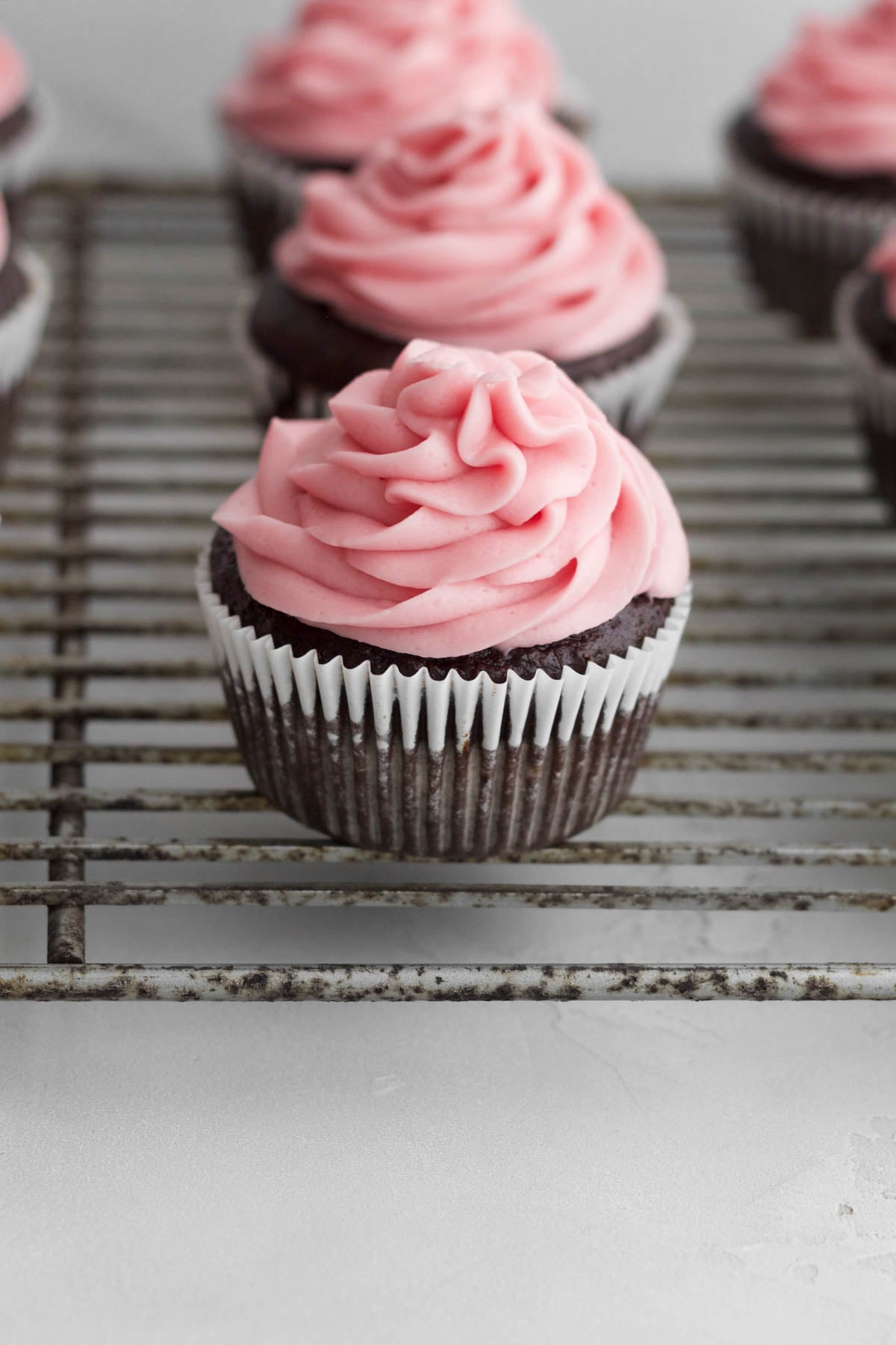 Pipping a tight swirl on the cupcakes.
