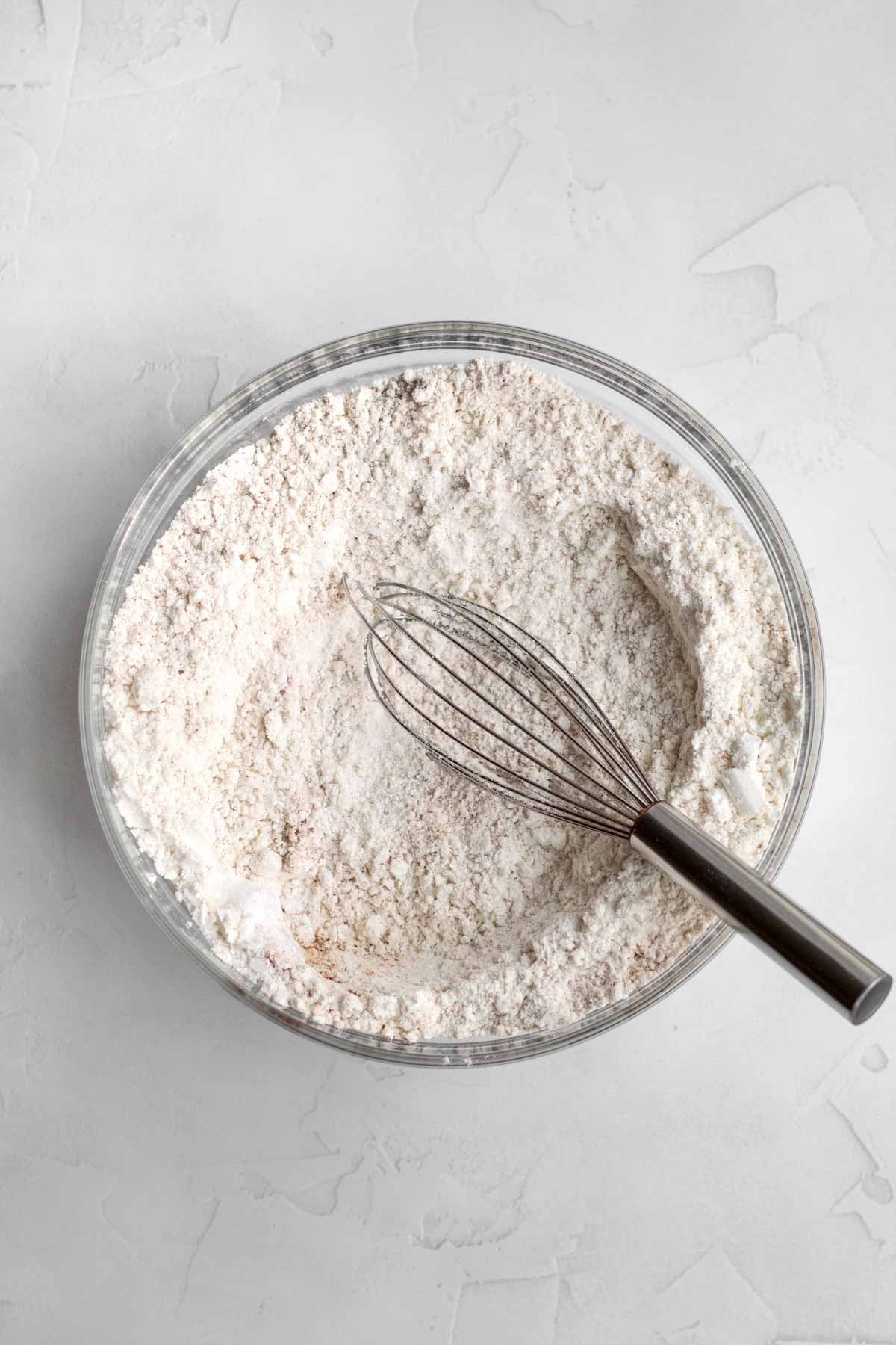 A whisk with the cinnamon infused dry ingredients.