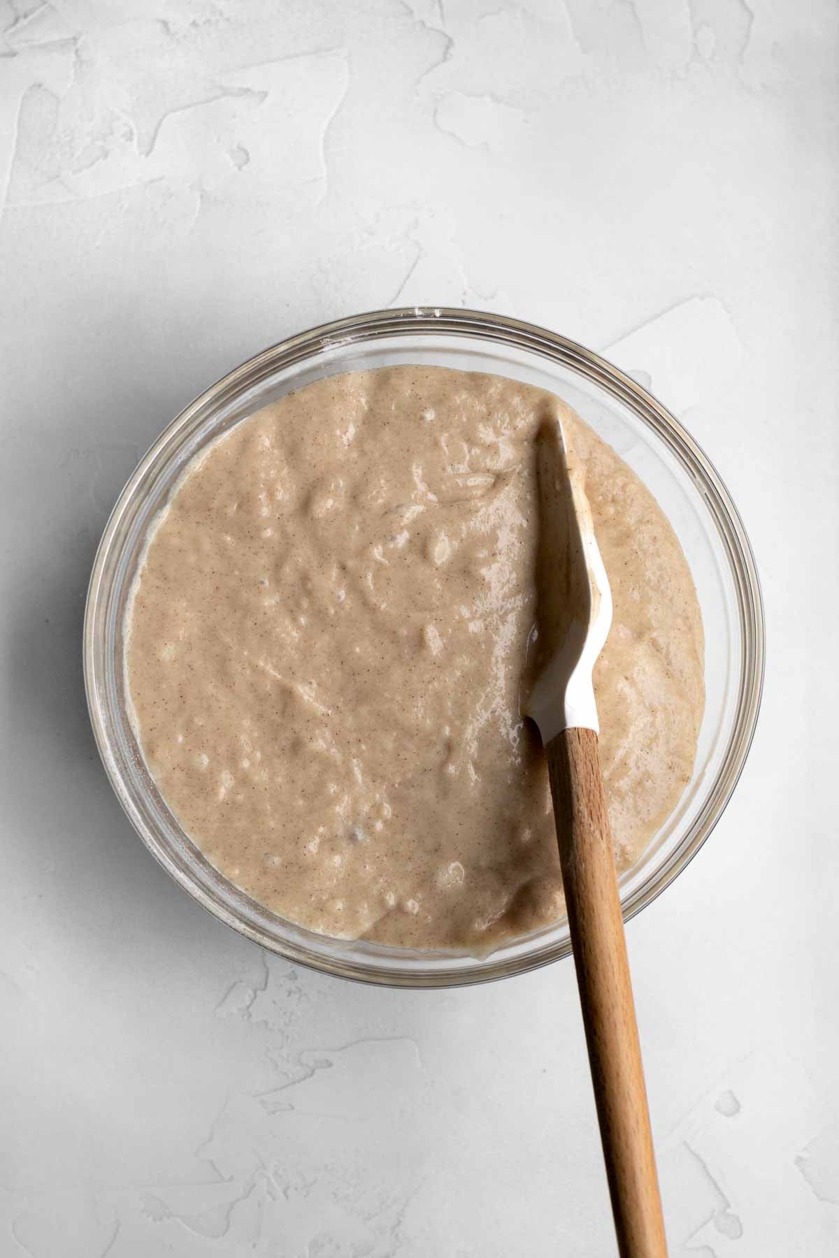Mixing the wet into the dry to make the cake batter.