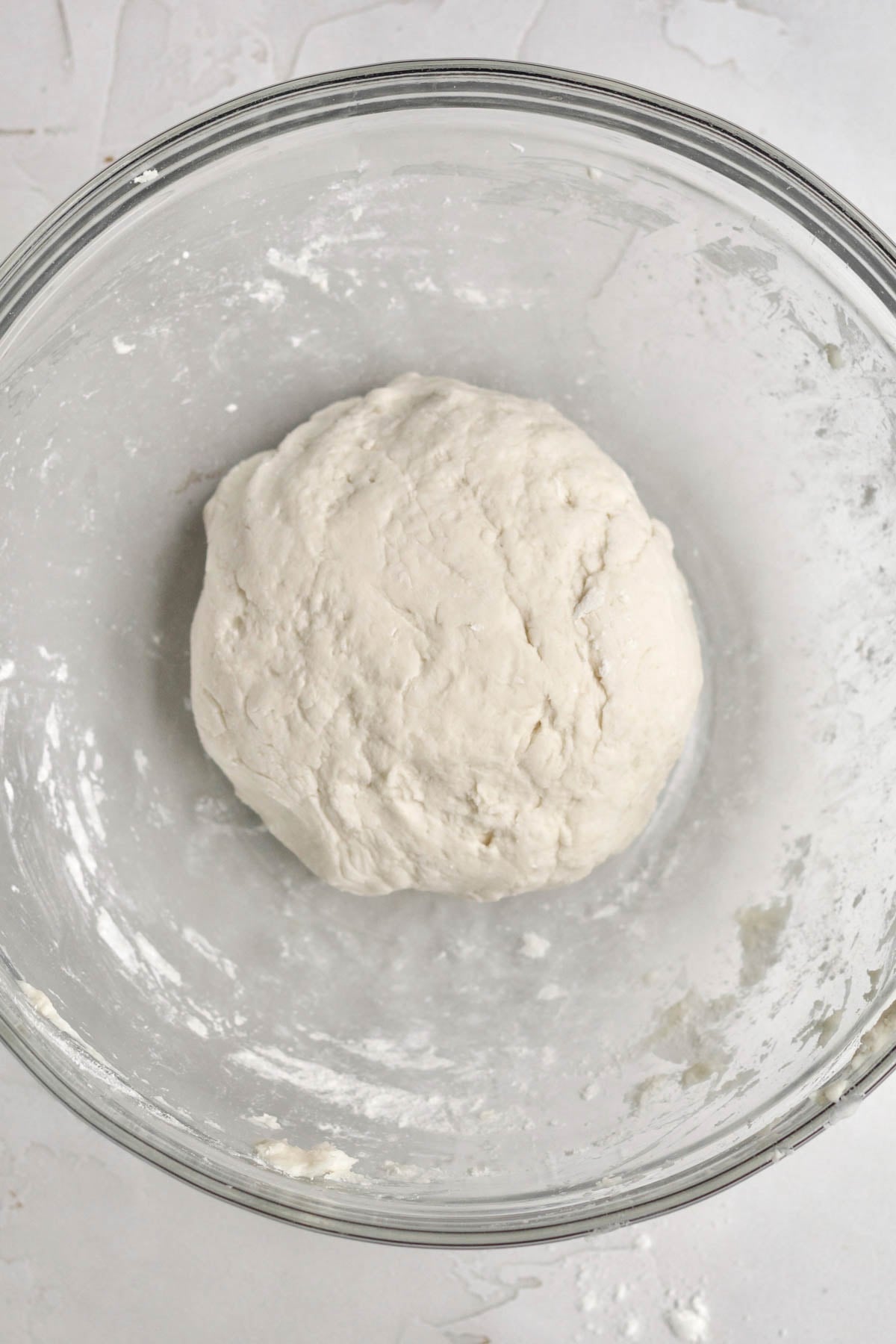 Mixing the yeast water into the dry ingredients to make a pizza dough.