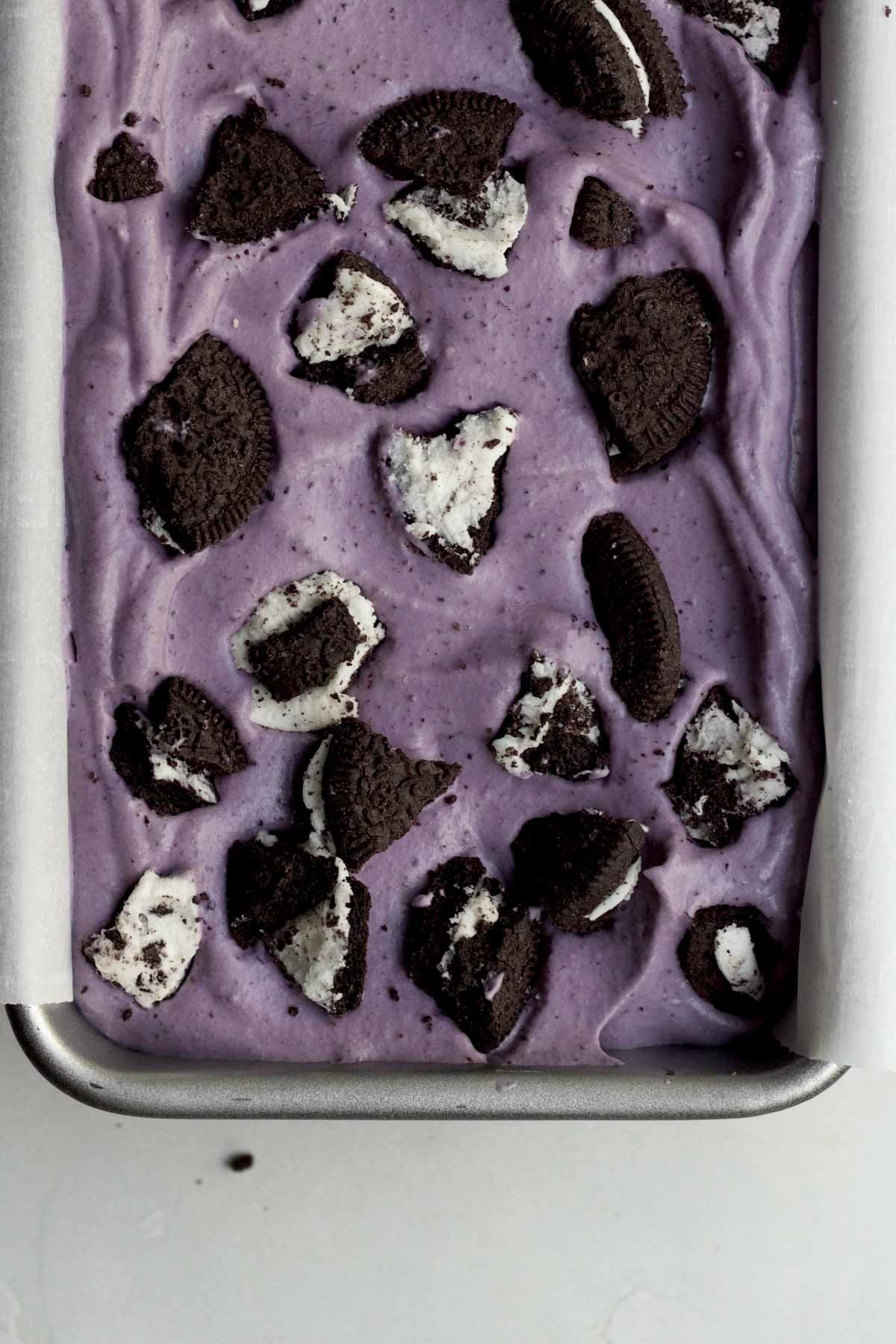 Broken chocolate sandwich sharps stick out from the Oreo blueberry ice cream.