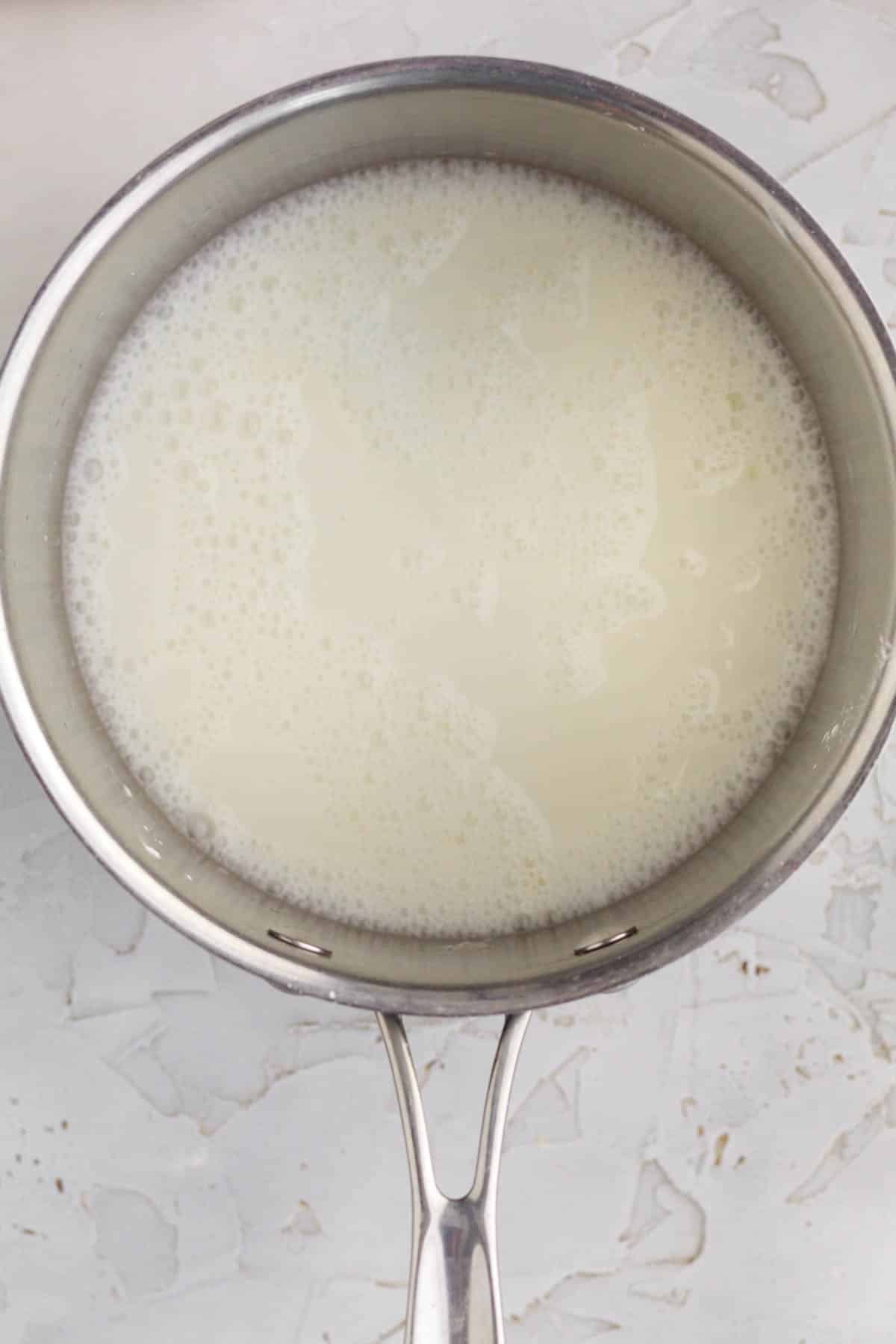 Mixing in milk, water and lemon juice.