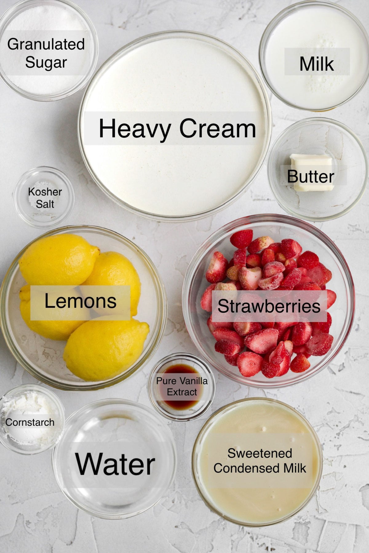 Strawberry swirl ice cream in separate bowls: granulated sugar, heavy cream, milk, butter, lemons, strawberries, cornstarch, water, pure vanilla extract, and sweetened condensed milk.