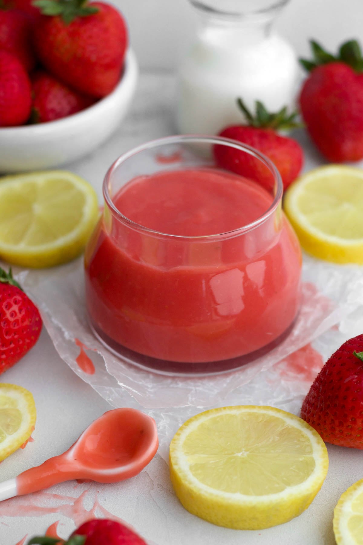 A glass jar of luscious strawberry curd.