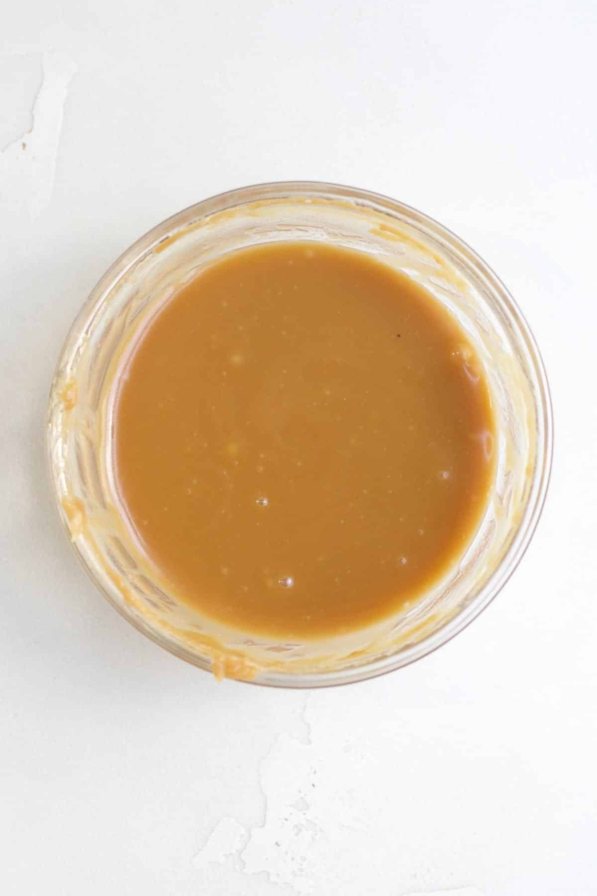Warm caramel drip in a glass bowl.