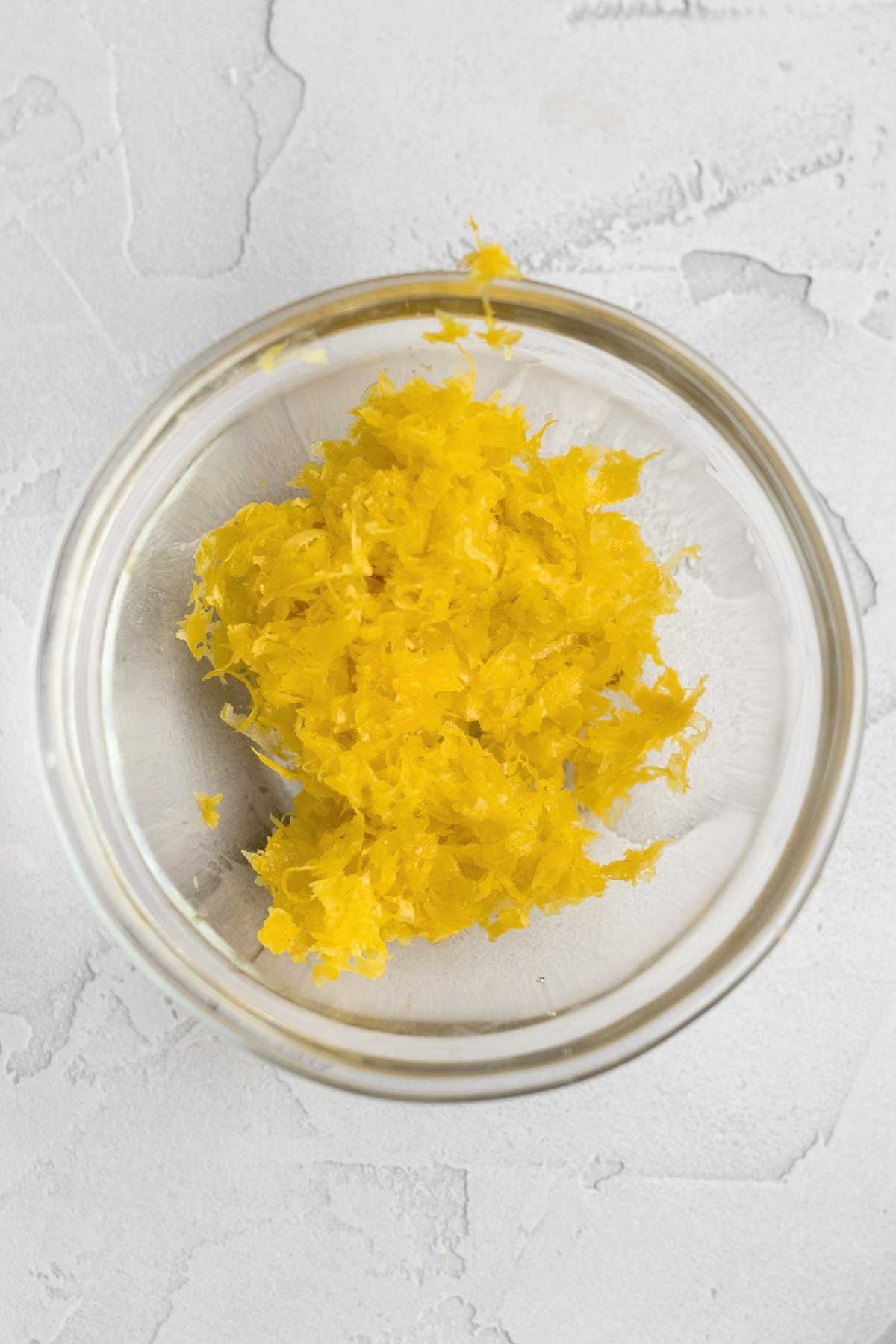 A bowl of bright yellow lemon zest.