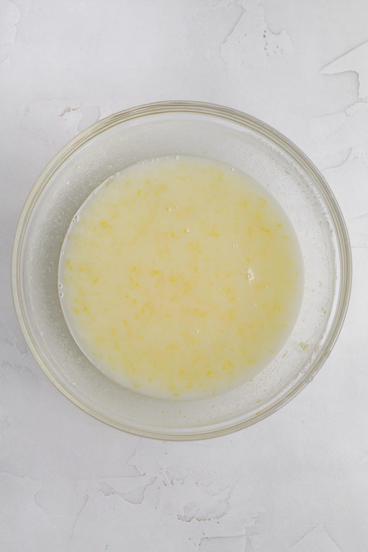 Mixing in the wet ingredients, sugar and zest together.