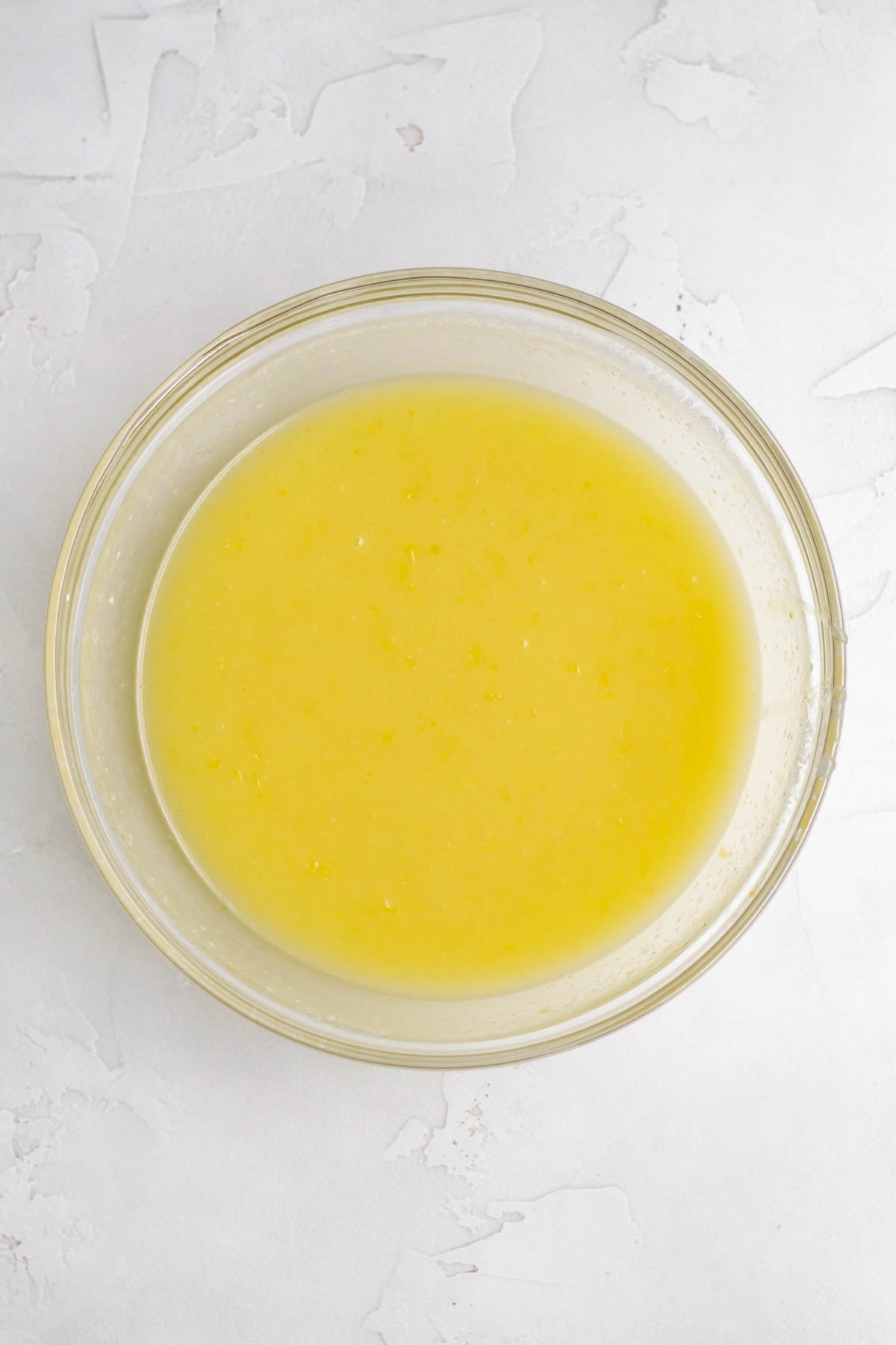 Whisking in the olive oil to the yellow mixture.