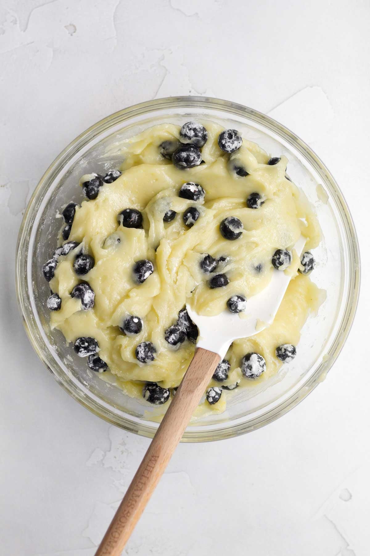 Mixing in the dry ingredients and blueberries.