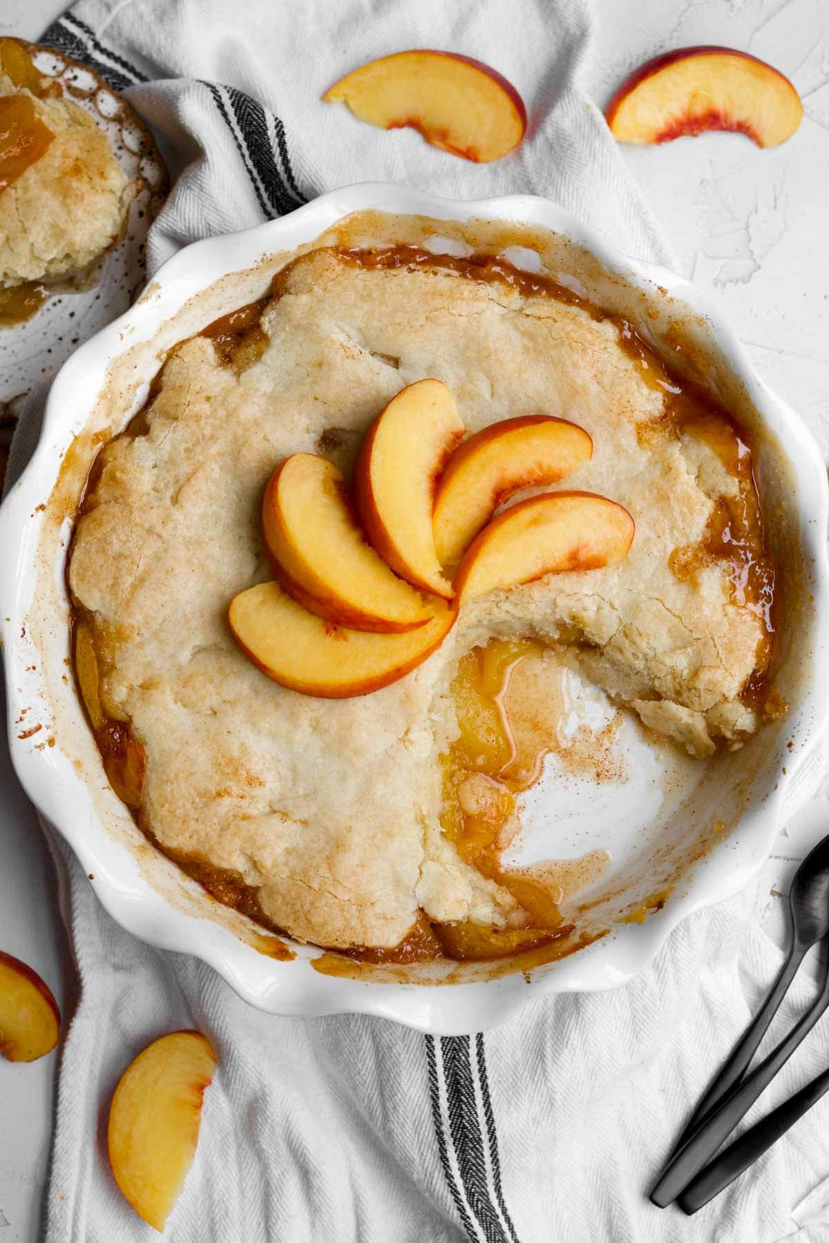 The golden crust of this gluten free peach cobbler reveals its bubbly, warm peach filling.