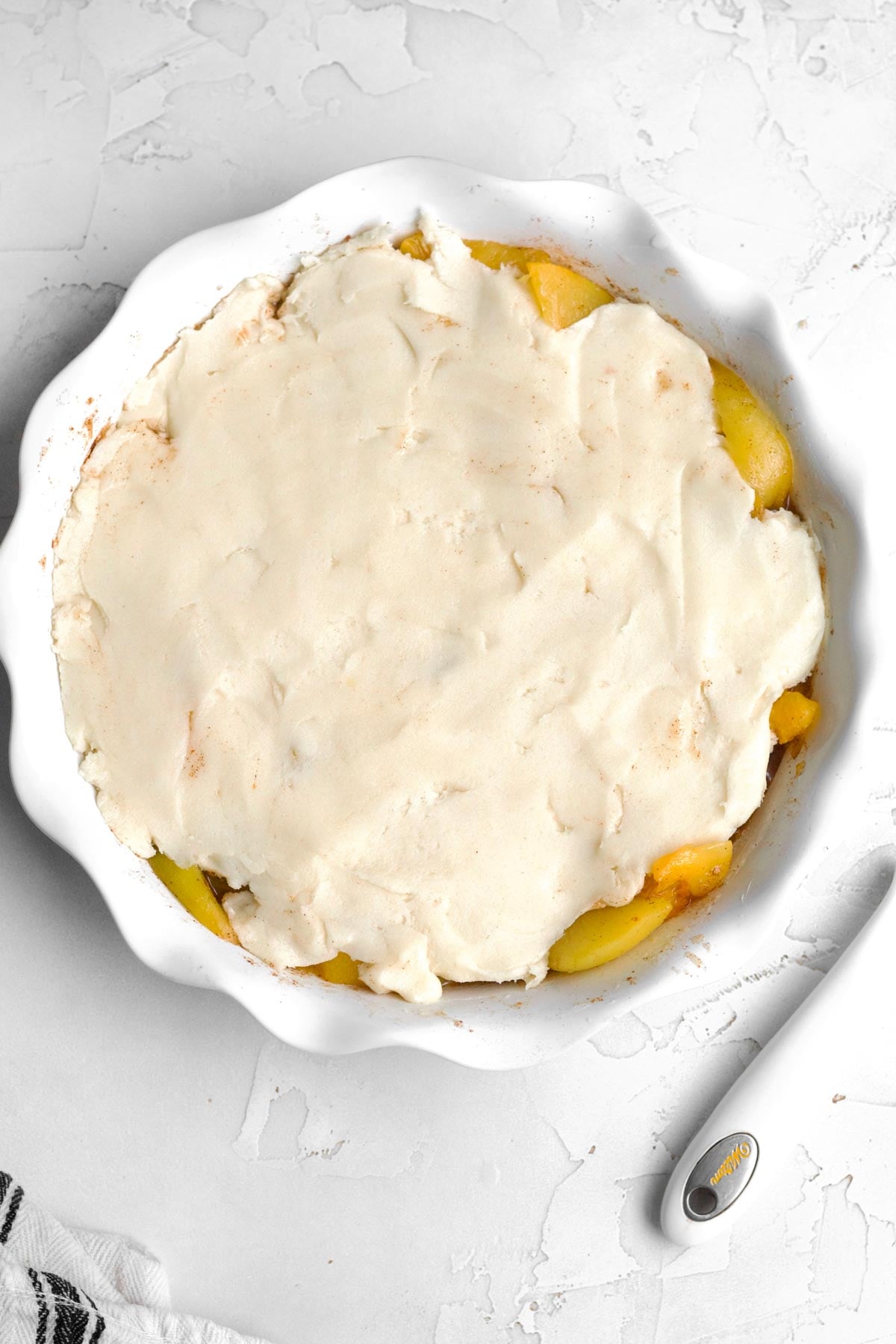 Smoothing out the gluten free peach cobbler batter.
