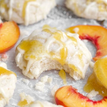 Soft, gluten-free peach cookie with a bite through the sugary peach glaze and strained peaches.