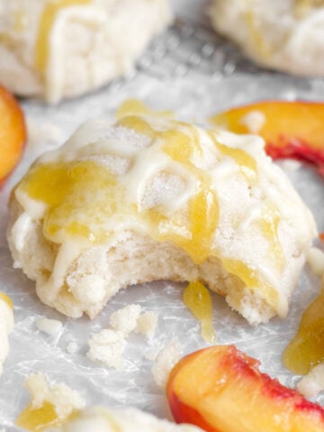 Soft, gluten-free peach cookie with a bite through the sugary peach glaze and strained peaches.