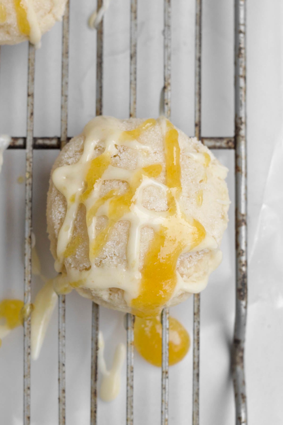 Drizzling the glaze and strained peaches on the cookie.