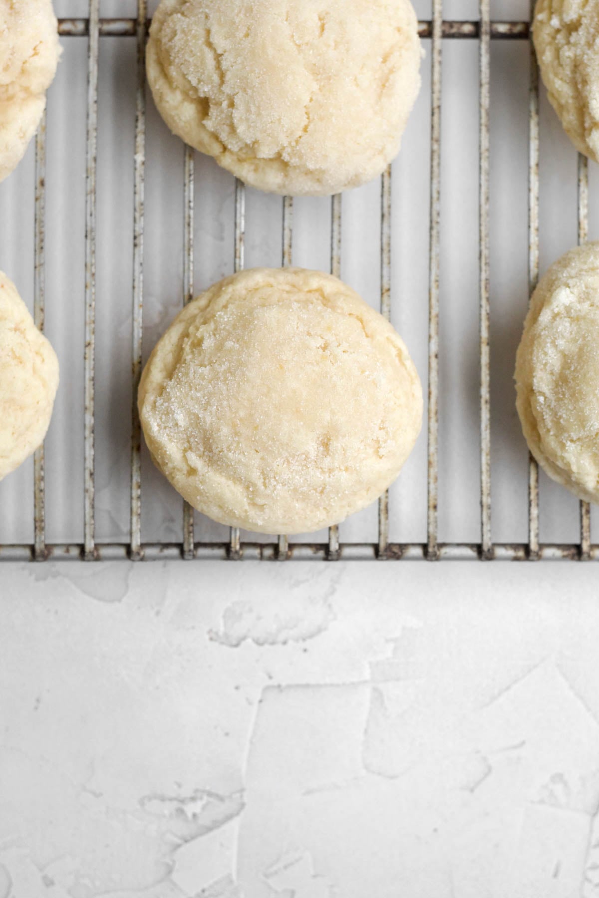 Fresh-baked peach cookies resting on a cooling rack.