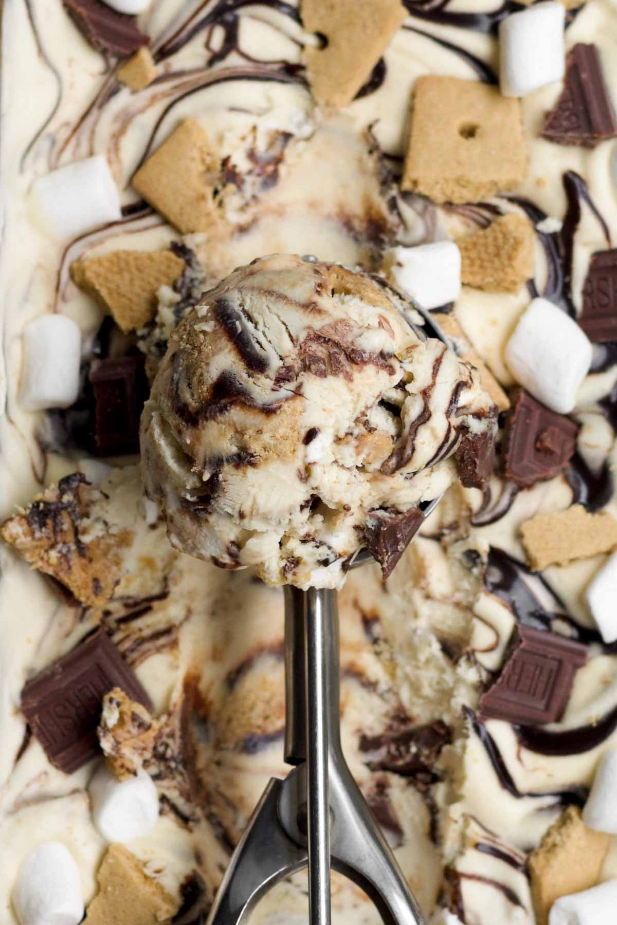 A textured scooped ball of gluten free s'mores ice cream above the pan.