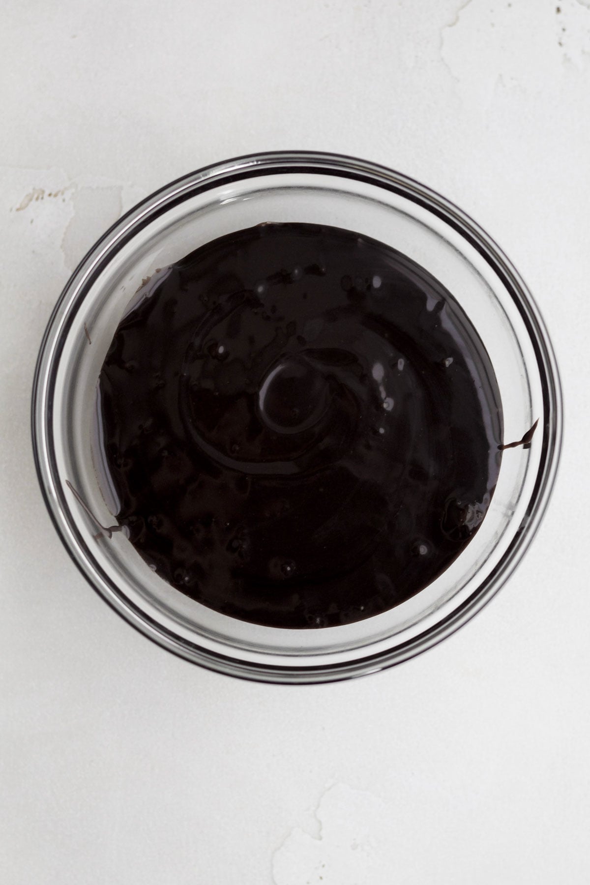 Warm dark fudge in a glass bowl.