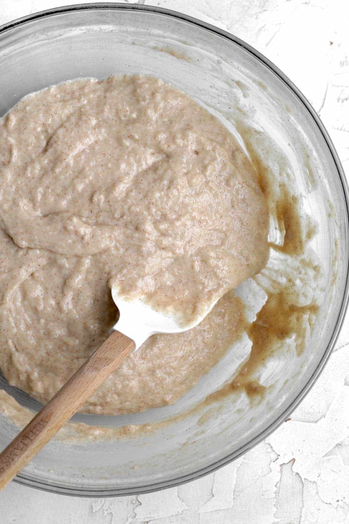 Mixing the wet and dry ingredients to make an apple loaf cake batter.