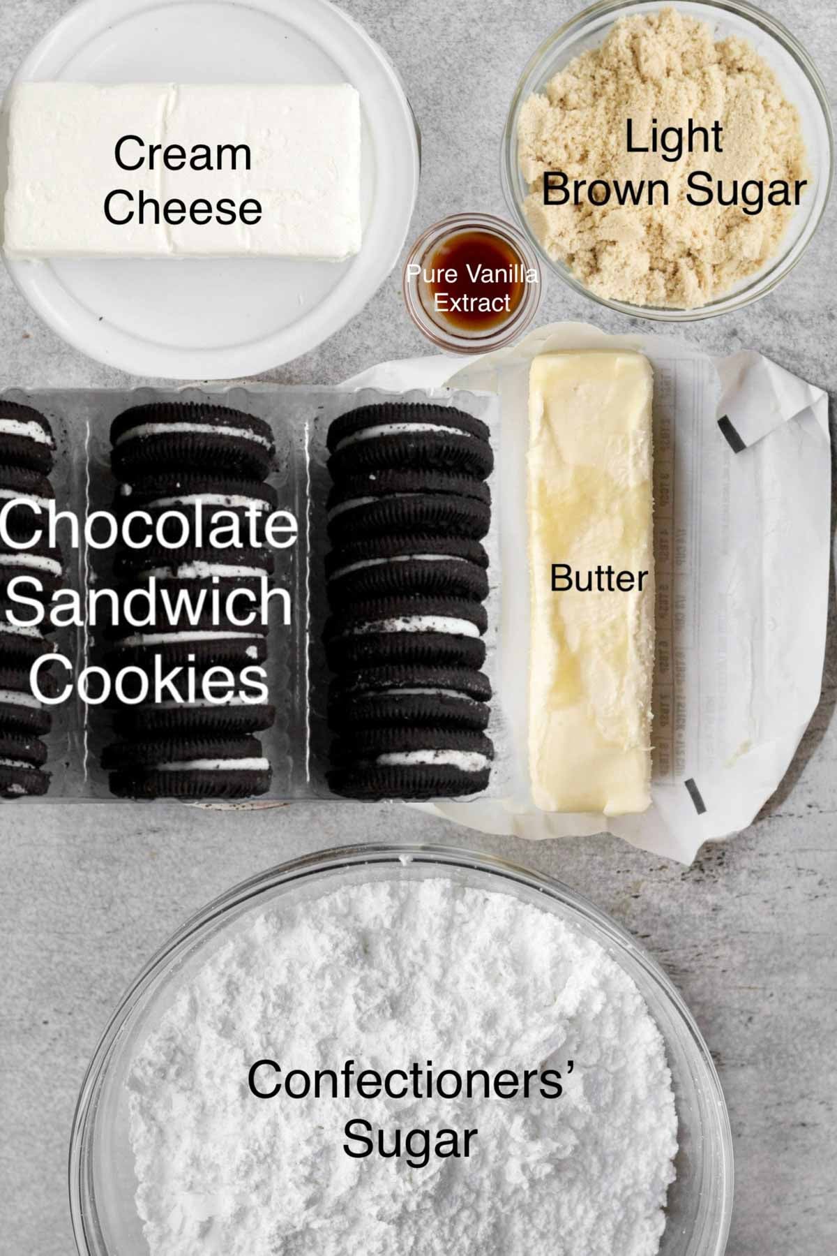 Oreo dip ingredients in separate containers: cream cheese, light brown sugar, pure vanilla extract, chocolate sandwich cookies, butter and confectioners' sugar.
