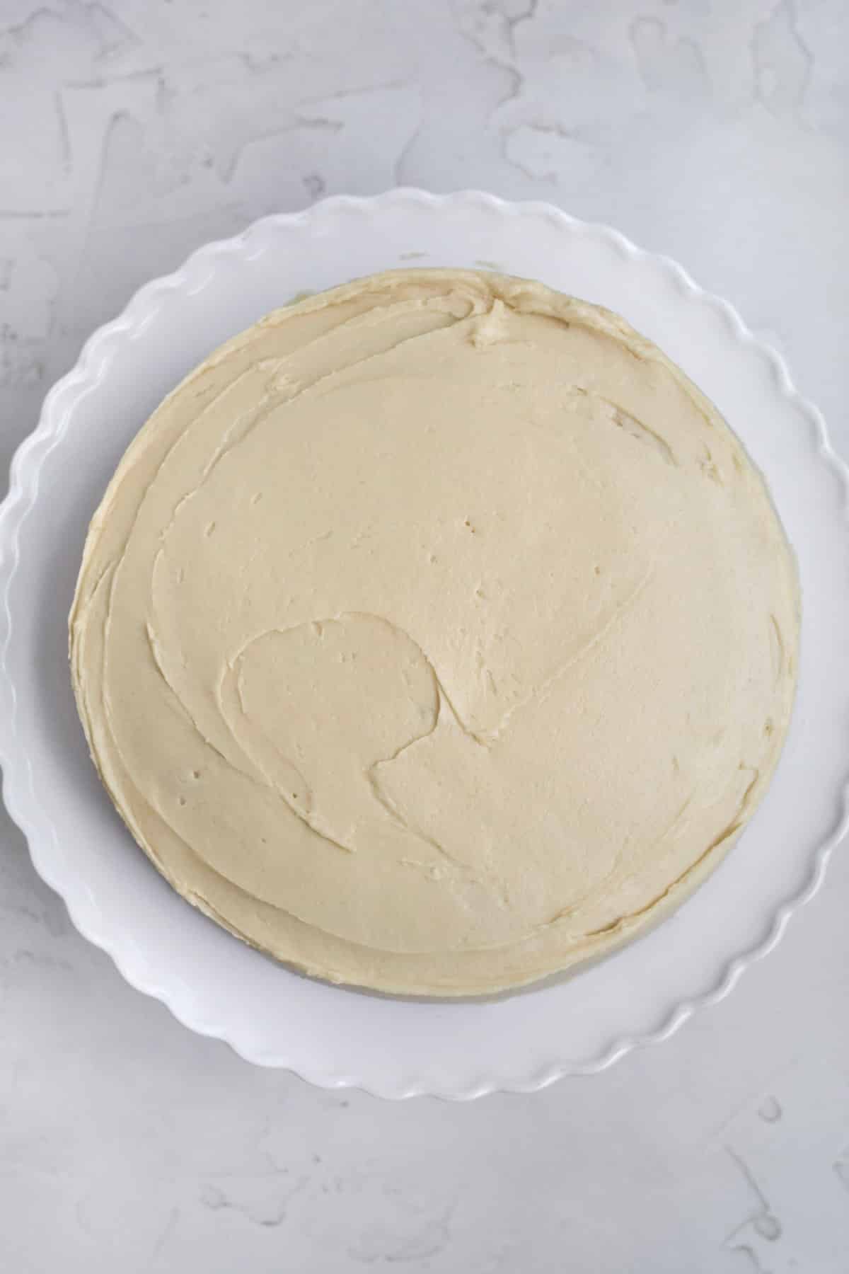 A whole cake frosted with creamy maple frosting.