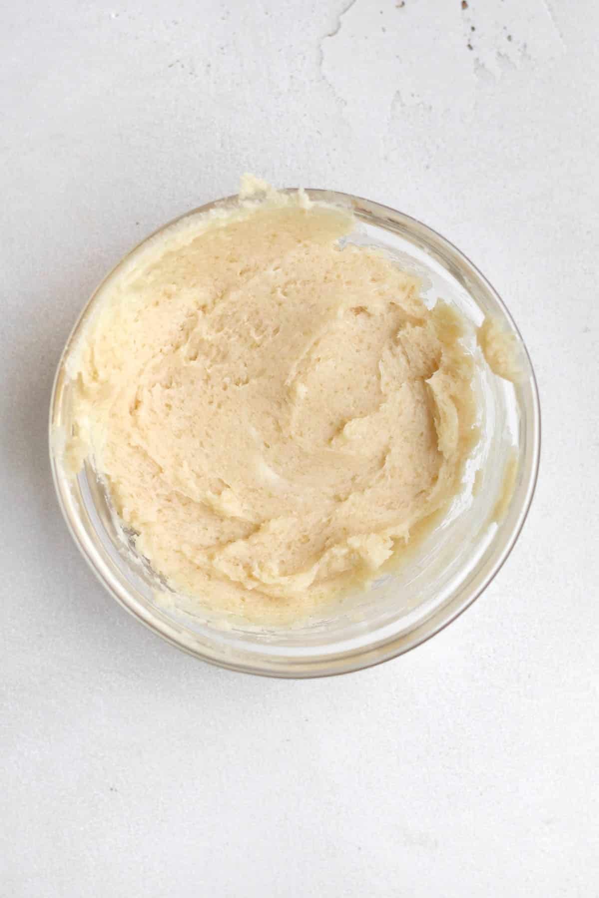 Butter and light brown sugar mixed in a bowl.